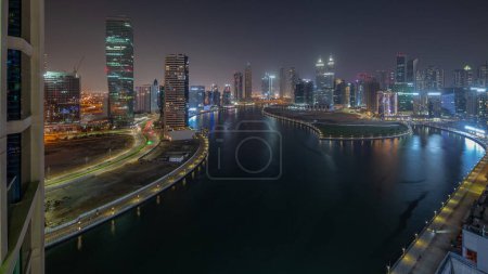 Photo for Cityscape of waterfront and skyscrapers in Dubai Business Bay with water canal aerial night . Modern skyline with illuminated towers. A center of international business - Royalty Free Image