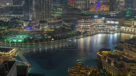 Photo for Dubai Fountain aerial night . Musical fountain, located in an artificial lake in downtown. Top view from above with evening illumination - Royalty Free Image