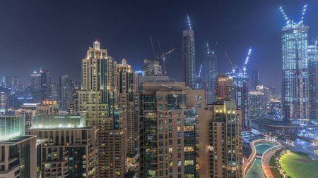 Téléchargez les photos : Panorama of downtown Dubai city aerial night . Urban skyline of business bay with modern skyscrapers and towers construction site from above - en image libre de droit