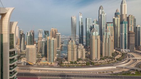 Photo for Skyscrapers of Dubai Marina with highest residential buildings morning . Aerial top view from JLT district during sunrise. Cloudy sky - Royalty Free Image