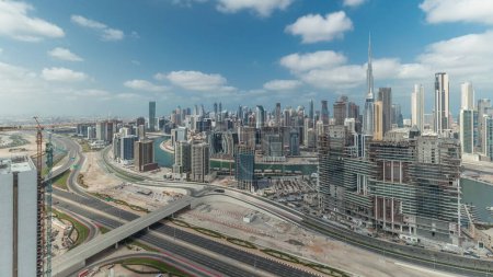Foto de Panorama showing skyline of Dubai with business bay and downtown district . Aerial view of many modern skyscrapers with cloudy blue sky. United Arab Emirates. - Imagen libre de derechos