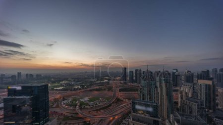 Photo for Huge highway crossroad junction between JLT district and Dubai Marina intersected by Sheikh Zayed Road aerial night panoramic. Golf course near illuminated towers and skyscrapers with busy traffic - Royalty Free Image