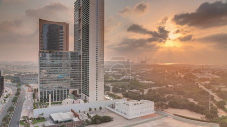 Photo for Sunrise in Dubai International Financial district transition . Aerial view of business office towers at morning. Skyscrapers with hotels near downtown - Royalty Free Image