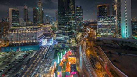 Photo for Panorama showing Dubai International Financial district night . Aerial view of business office towers. Illuminated skyscrapers with hotels and shopping malls near downtown - Royalty Free Image