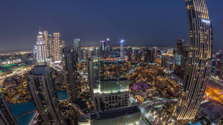 Photo for Aerial panorama of a big futuristic city day to night transition . Business bay and Downtown district with many skyscrapers and traditional houses, Dubai, United Arab Emirates skyline. - Royalty Free Image