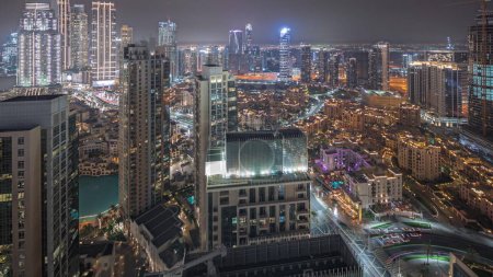 Téléchargez les photos : Panorama showing aerial view of a big futuristic city night . Business bay and Downtown district with many skyscrapers and traditional houses, Dubai, United Arab Emirates skyline. - en image libre de droit