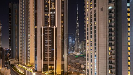 Foto de Panorama showing tallest skyscrapers during Earth hour in downtown dubai located on bouleward street near shopping mall aerial night . Lights turning off for one hour - Imagen libre de derechos
