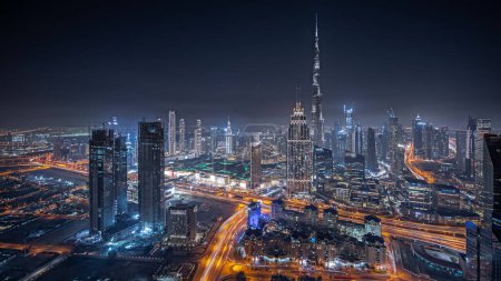 Photo for Panorama showing aerial view of tallest towers in Dubai Downtown skyline and highway night  panorama. Financial district and business area in smart urban city. Skyscraper and high-rise buildings - Royalty Free Image
