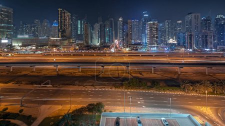 Photo for Panorama showing Dubai marina tallest block of skyscrapers night . Aerial view from JLT district to apartment buildings, hotels and office towers near highway. - Royalty Free Image