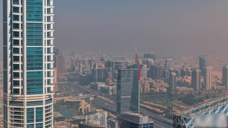 Téléchargez les photos : Dubaï Vue aérienne montrant la brume sur les hauteurs al barsha et la zone du quartier des verts pendant toute la journée depuis la marina de Dubaï. Tours et gratte-ciel jour brumeux d'en haut - en image libre de droit