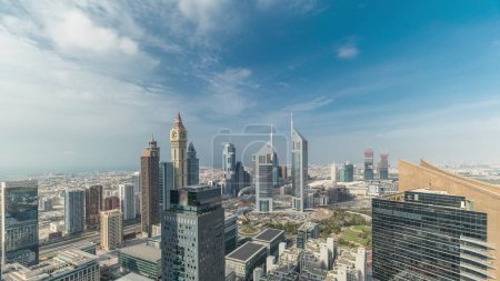 Panorama of futuristic skyscrapers in financial district business center in Dubai on Sheikh Zayed road . Aerial view from above with beautiful cloudy sky