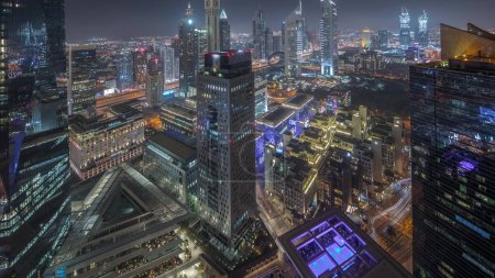 Photo for Panorama of futuristic skyscrapers in financial district business center in Dubai on Sheikh Zayed road night . Aerial view from above with illuminated towers and hotels - Royalty Free Image