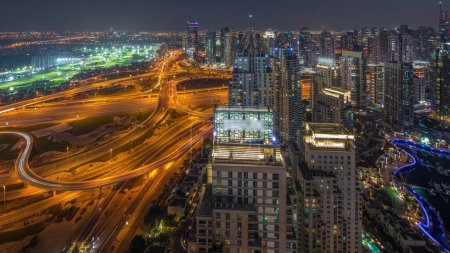 Photo for Dubai marina and JLT skyscrapers along Sheikh Zayed Road aerial day to night transition . Residential and office buildings from above with big crossroad - Royalty Free Image