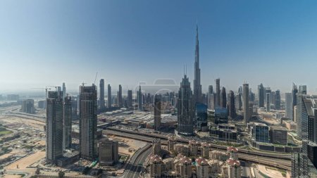 Téléchargez les photos : Panorama showing aerial view of tallest towers in Dubai Downtown skyline and highway . Financial district and business area in smart urban city. Skyscraper and high-rise buildings - en image libre de droit