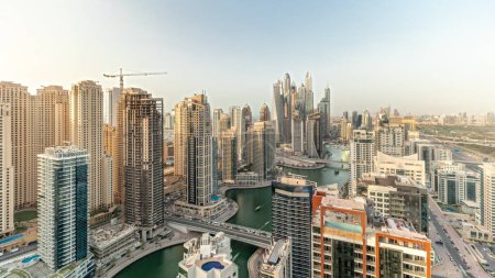 Foto de Panorama showing various skyscrapers in tallest recidential block in Dubai Marina aerial  with artificial canal. Many towers and yachts - Imagen libre de derechos