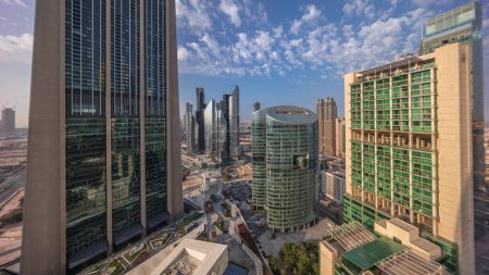Photo for Dubai international financial center skyscrapers with promenade on a gate avenue aerial timelapse during all day from sunrise to sunset. Shadows moving fast - Royalty Free Image