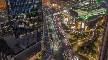 Photo for Aerial panorama of Downtown Dubai with shopping mall and traffic on a street day to night transition timelapse from above, UAE Modern skyscrapers and hotels - Royalty Free Image