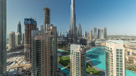 Photo for Panorama showing Dubai Downtown cityscape with tallest skyscrapers around aerial timelapse. Construction site of new towers and busy roads with traffic from above - Royalty Free Image