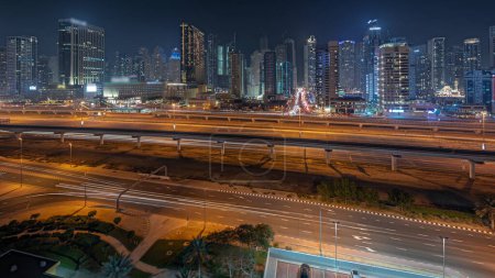 Foto de Panorama showing Dubai marina tallest block of skyscrapers night . Aerial view from JLT district to apartment buildings, hotels and office towers near highway. - Imagen libre de derechos