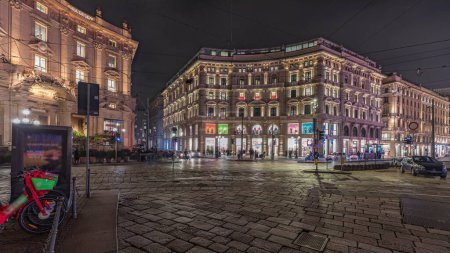 Photo for Panorama showing the Cordusio Square night timelapse. Illuminated historic buildings, monument and tram traffic. One of squares in the center of the city at the crossroads of six old streets. - Royalty Free Image