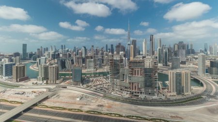 Photo for Panorama showing skyline of Dubai with business bay and downtown district. Aerial view of many modern skyscrapers with cloudy blue sky. United Arab Emirates. - Royalty Free Image