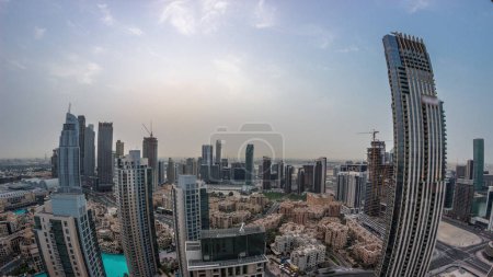 Photo for Aerial panorama of a big futuristic city night to day transition. Business bay and Downtown district before sunrise with skyscrapers and traditional houses, Dubai, United Arab Emirates skyline. - Royalty Free Image
