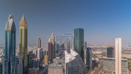 Skyline view of the high-rise buildings on Sheikh Zayed Road in Dubai aerial timelapse, UAE. Skyscrapers in International Financial Centre financial hub from above. Shadows moving fast