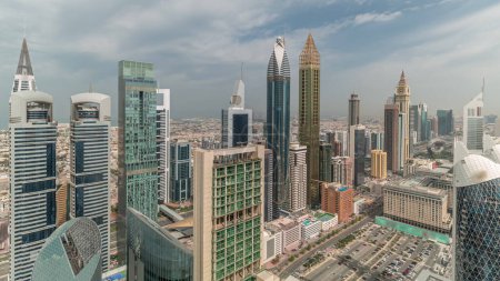 Photo for Skyline view of the high-rise buildings on Sheikh Zayed Road in Dubai aerial panoramic timelapse, UAE. Skyscrapers in International Financial Centre financial hub from above with cloudy sky - Royalty Free Image
