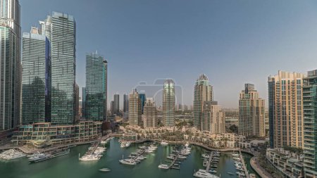 Photo for Panorama showing Dubai marina tallest skyscrapers and yachts in harbor aerial. View at apartment buildings, hotels and office blocks, modern residential development of UAE - Royalty Free Image