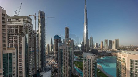 Photo for Panorama showing Dubai Downtown skyline cityscape with tallest skyscrapers around aerial. Construction site of new towers and busy roads with traffic from above - Royalty Free Image