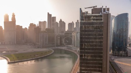 Photo for Cityscape skyscrapers of Dubai Business Bay with water canal aerial during all day with shadows moving fast. Modern skyline with towers and waterfront. A center of international business - Royalty Free Image