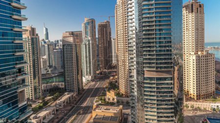 Téléchargez les photos : Panorama showing Dubai Marina and JBR area and the famous Ferris Wheel aerial and golden sand beaches in the Persian Gulf during sunrise - en image libre de droit