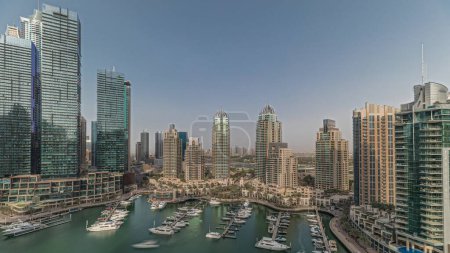 Photo for Panorama showing Dubai marina tallest skyscrapers and yachts in harbor aerial. View at apartment buildings, hotels and office blocks, modern residential development of UAE - Royalty Free Image