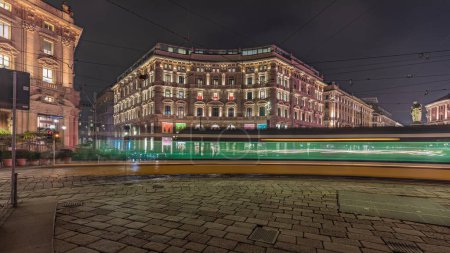 Photo for Panorama showing the Cordusio Square night timelapse. Illuminated historic buildings, monument and tram traffic. One of squares in the center of the city at the crossroads of six old streets. - Royalty Free Image