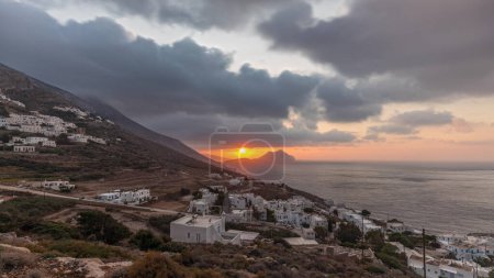 Photo for Panorama showing sunset on Amorgos island aerial timelapse from above. Traditional Greece - white houses on hills and turquoise sea, Cyclades - Royalty Free Image