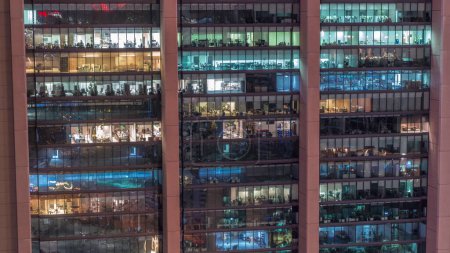 Photo for Big glowing windows in modern office and residential buildings day to night transition timelapse, in rows of windows light turning on and shines. End of the working day - Royalty Free Image