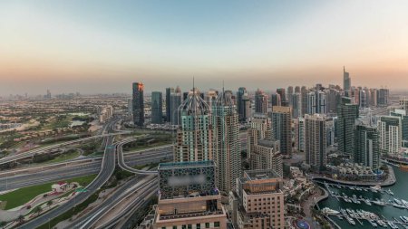 Photo for Panorama showing Dubai marina and JLT skyscrapers along Sheikh Zayed Road with huge junction near golf course and media city district aerial timelapse. Residential and office buildings from above. - Royalty Free Image