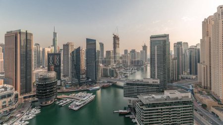 Foto de Panorama showing overview to JBR and Dubai Marina skyline with modern high rise skyscrapers waterfront living apartments aerial. Yachts floating on water of canal. JLT district on a background - Imagen libre de derechos