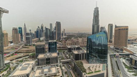 Photo for Panorama showing futuristic Dubai Downtown and financial district skyline aerial. Many towers and skyscrapers with traffic on streets. City walk district on a background - Royalty Free Image