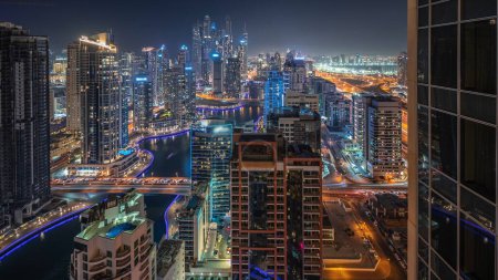 Photo for Panorama showing various skyscrapers in tallest residential block in Dubai Marina and JDR district aerial night with artificial canal. Many towers and yachts - Royalty Free Image