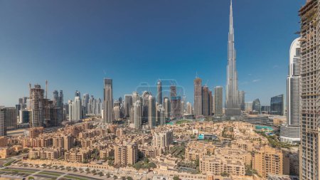 Photo for Panorama showing Dubai's business bay and downtown towers aerial morning. Rooftop view of some skyscrapers and new buildings under construction with traditional houses of old town district - Royalty Free Image