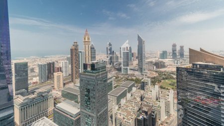 Photo for Panorama showing many futuristic skyscrapers in financial district business center in Dubai on Sheikh Zayed road. Aerial view from above with clouds - Royalty Free Image