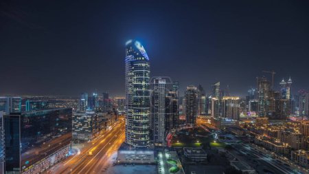 Foto de Panorama showing Dubai Downtown and business bay night with tallest skyscraper and other illuminated towers view from the top in Dubai, United Arab Emirates. - Imagen libre de derechos