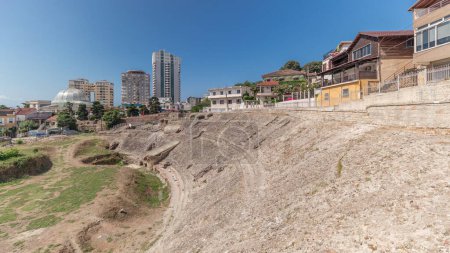 Foto de Panorama mostrando el timelapse del Anfiteatro de Durres (Amphitheatrum Dyrrhachium) desde arriba. Ruinas del antiguo anfiteatro romano en el centro de Durres, Albania. - Imagen libre de derechos