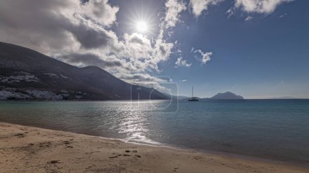 Photo for Panorama showing Amorgos island aerial timelapse from above with clouds on a blue sky. Traditional Greece - beach with hills and turquoise sea, Cyclades - Royalty Free Image