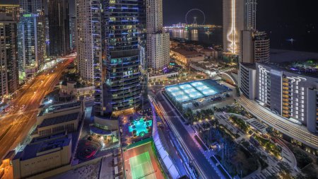 Photo for Panorama showing Dubai Marina and JBR area and the famous Ferris Wheel aerial night timelapse and illuminated skyscrapers and traffic on streets - Royalty Free Image