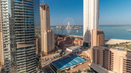 Photo for Panorama showing Dubai Marina and JBR area and the famous Ferris Wheel aerial timelapse and golden sand beaches in the Persian Gulf during sunrise - Royalty Free Image