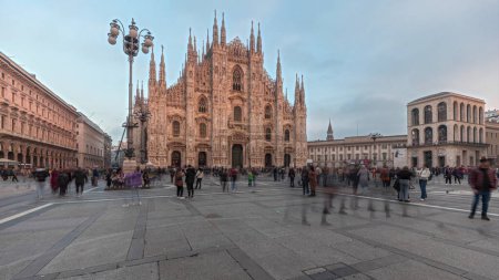 Photo for Panorama showing Milan Cathedral and historic buildings timelapse during sunset. Duomo di Milano is the cathedral church located at the Piazza del Duomo square in Milan city in Italy - Royalty Free Image