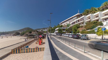 Téléchargez les photos : Panorama showing the coastline and waterfront road of the village of Sesimbra timelapse, in the middle of the Atlantic Ocean. View of the beach. Portugal - en image libre de droit