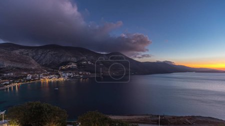 Photo for Panorama showing Amorgos island aerial day to night transition timelapse from above after sunset. Traditional Greece - white houses on hills and turquoise sea, Cyclades - Royalty Free Image